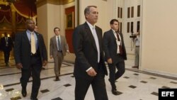 El presidente de la Cámara baja, John Boehner (C), entra a la Cámara de Representantes para participar en una serie de votaciones nocturnas sobre el presupuesto.